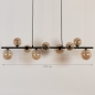 Foto 15253-1: Langwerpige hanglamp in het zwart met negen bollen van glas in amber kleur